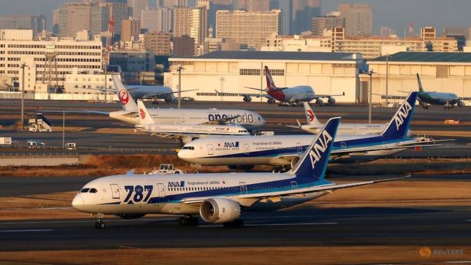 FILE PHOTO: ANA's Boeing 787 taxis in front of other aircraft at the Tokyo International Airpo