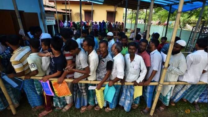 people-wait-in-queue-to-check-their-names-on-the-draft-list-at-the-national-register-of-citizens.jpg