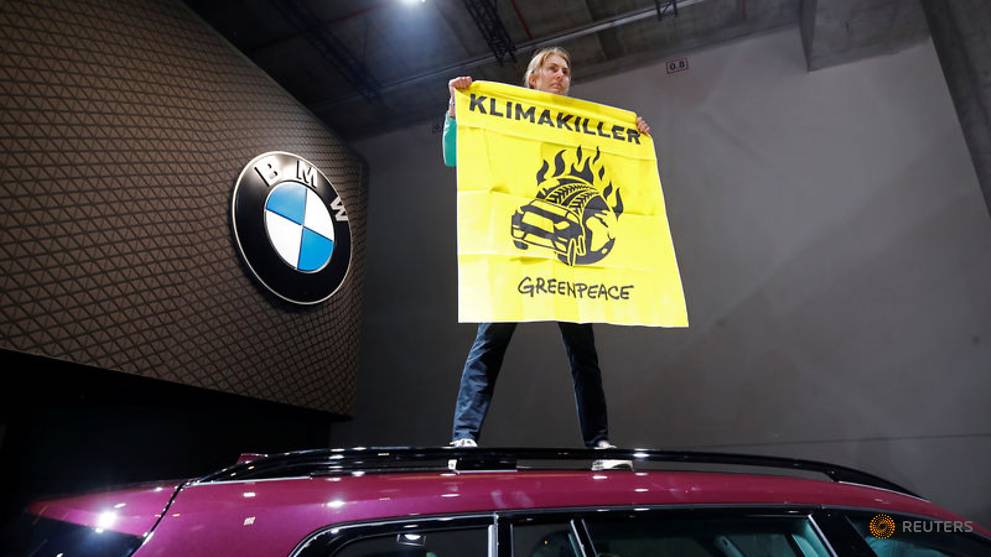 'Climate killer' protester rushes Merkel's stage at Frankfurt car show - CNA