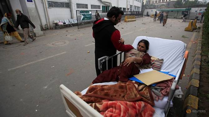 a-relative-takes-care-of-a-patient-on-a-bed-after-she-was-taken-out-of-her-ward-when-a-group-of-lawyers-stormed-the-punjab-institute-of-cardiology--pic--in-lahore-3.jpg