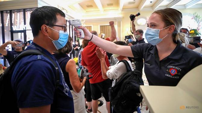 a-medical-worker-checks-the-temperature-of-an-arriving-guest-during-the-reopening-of-bellagio-hotel-casino--in-las-vegas-1.jpg