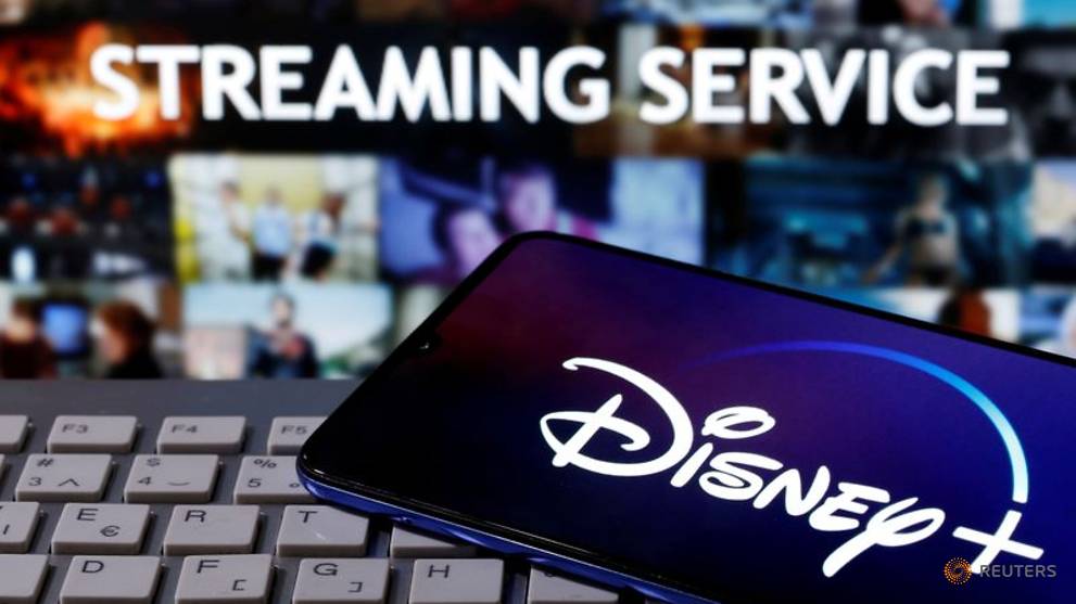 file-photo--smartphone-with-displayed--quot-disney-quot--logo-is-seen-on-the-keyboard-in-front-of-displayed--quot-streaming-service-quot--words-in-this-illustration-4.jpg