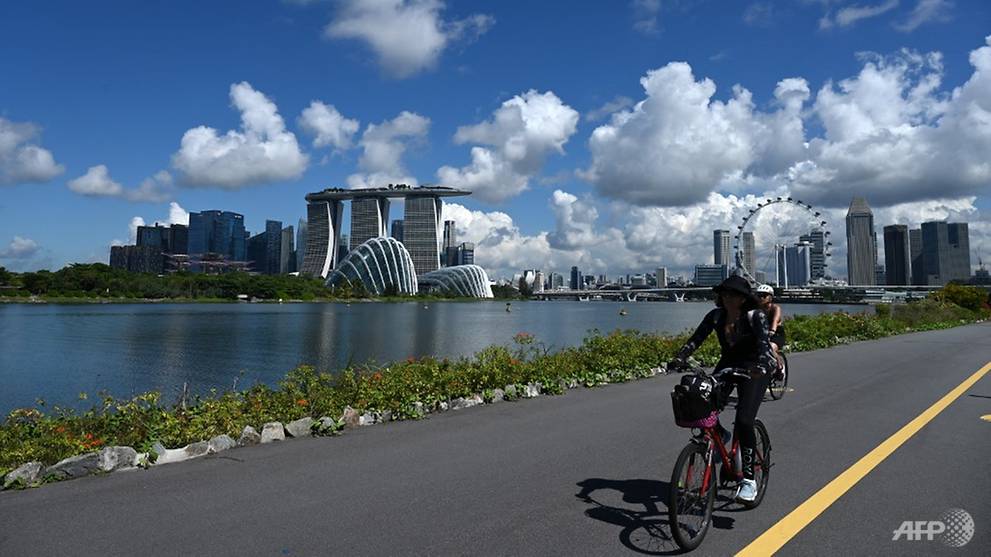 [Image: cyclists-are-seen-in-singapore-with-mari...ground.jpg]